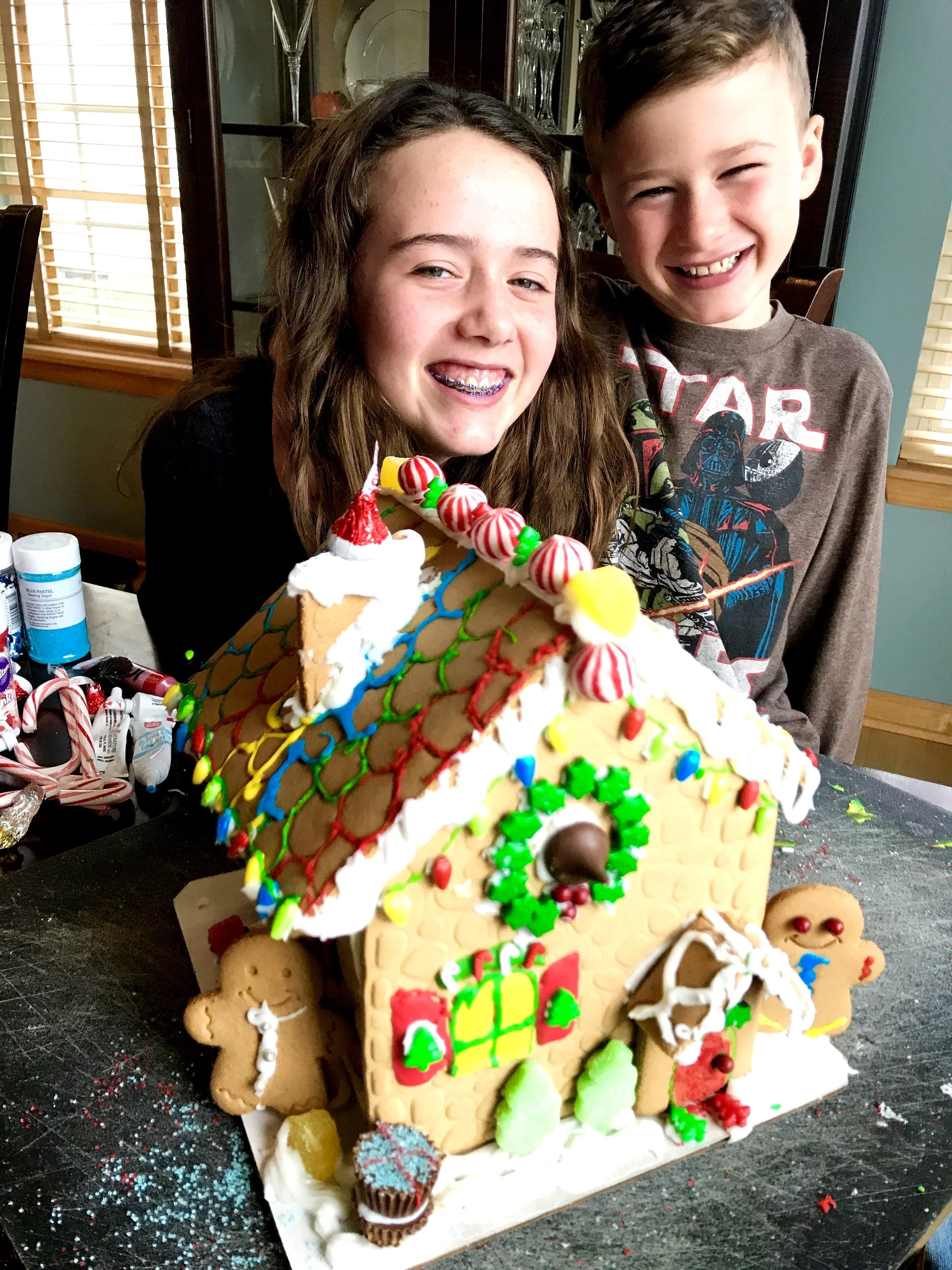 The kiddos with the gingerbread house (from a kit) they decorated together. Love those smiles!