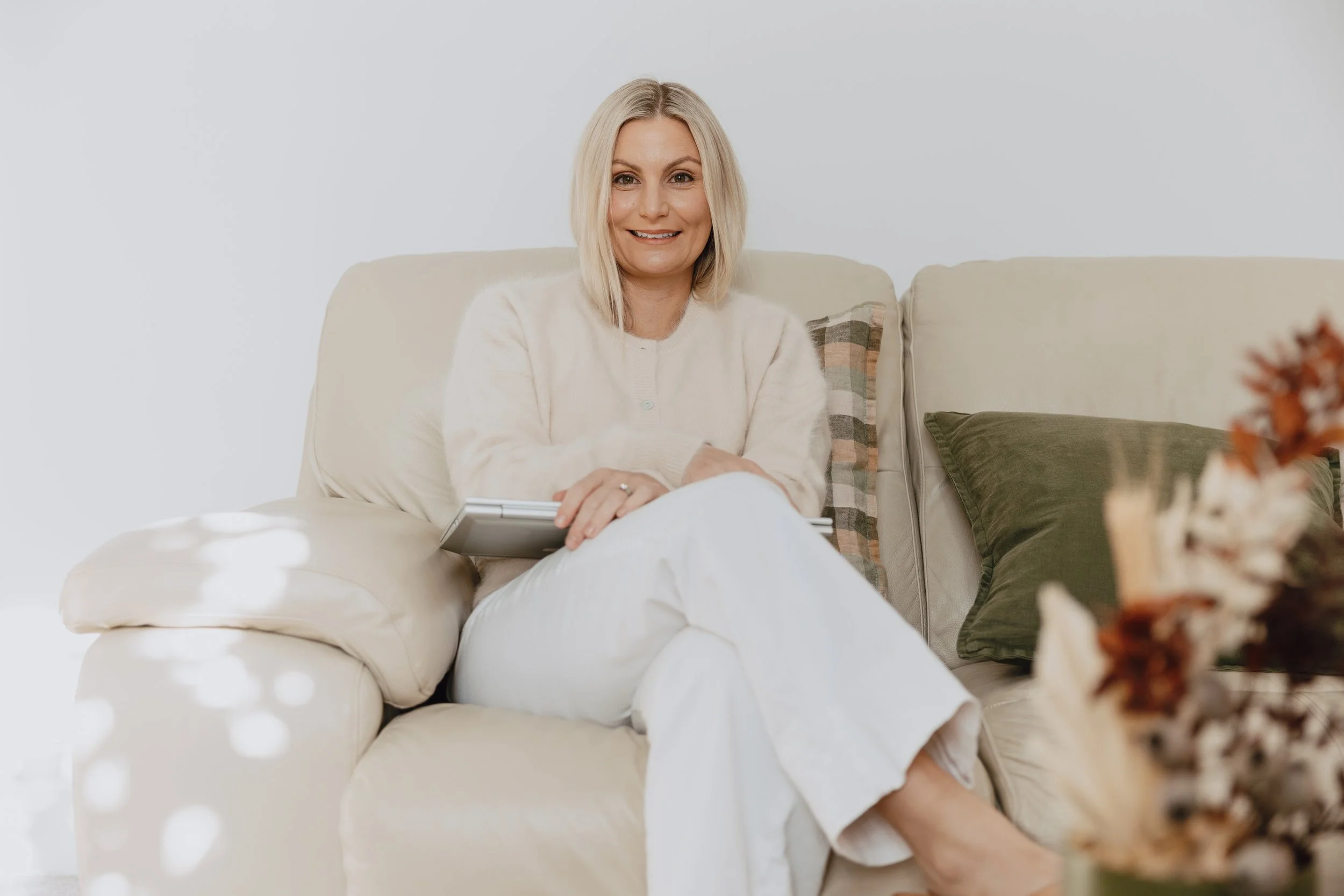 Erin in white on couch on laptop.jpg