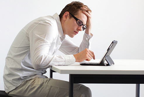 493ss_thinkstock_rf_man_hunched_over_tablet.jpg