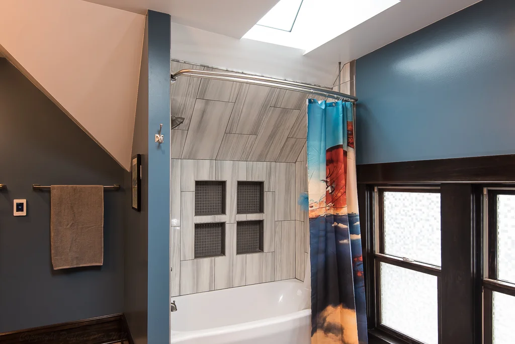 Finished master bathroom is flooded with natural light through the use of skylights and windows.
