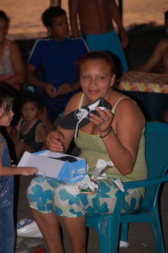 Suyapa opening presents at last year’s beach Christmas
