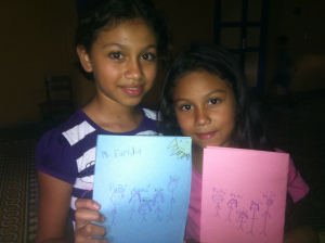 Two beautiful girls and the drawings they made during Sunday School class