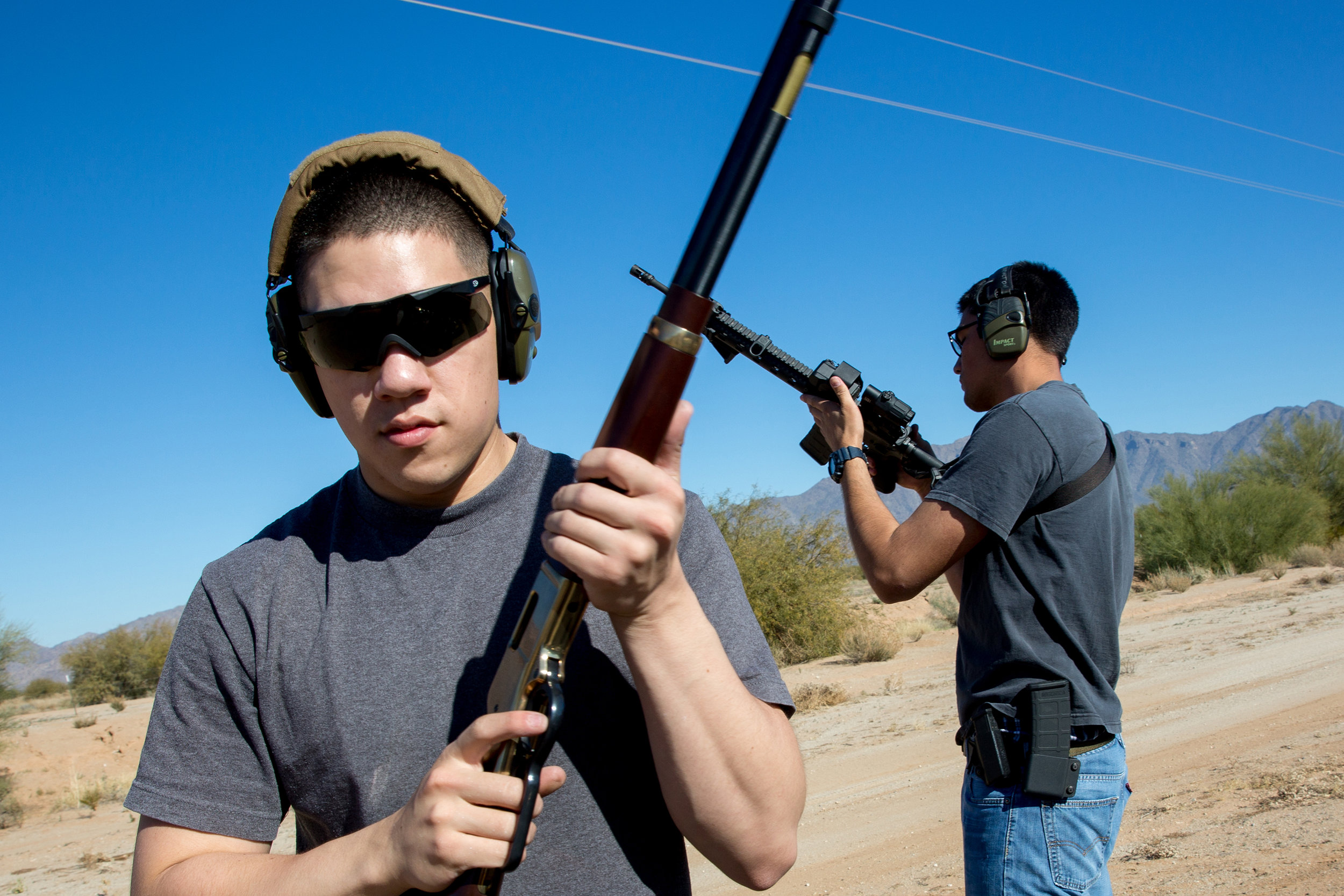  Lance Cpl. Ben Fouse (left) and Petty Officer 3rd Class Thomas Warrington (right) prepare their guns to shoot at targets in the Goodyear desert on Dec. 18, 2015. The two were trained in gun safety and take every precaution to ensure their proper use