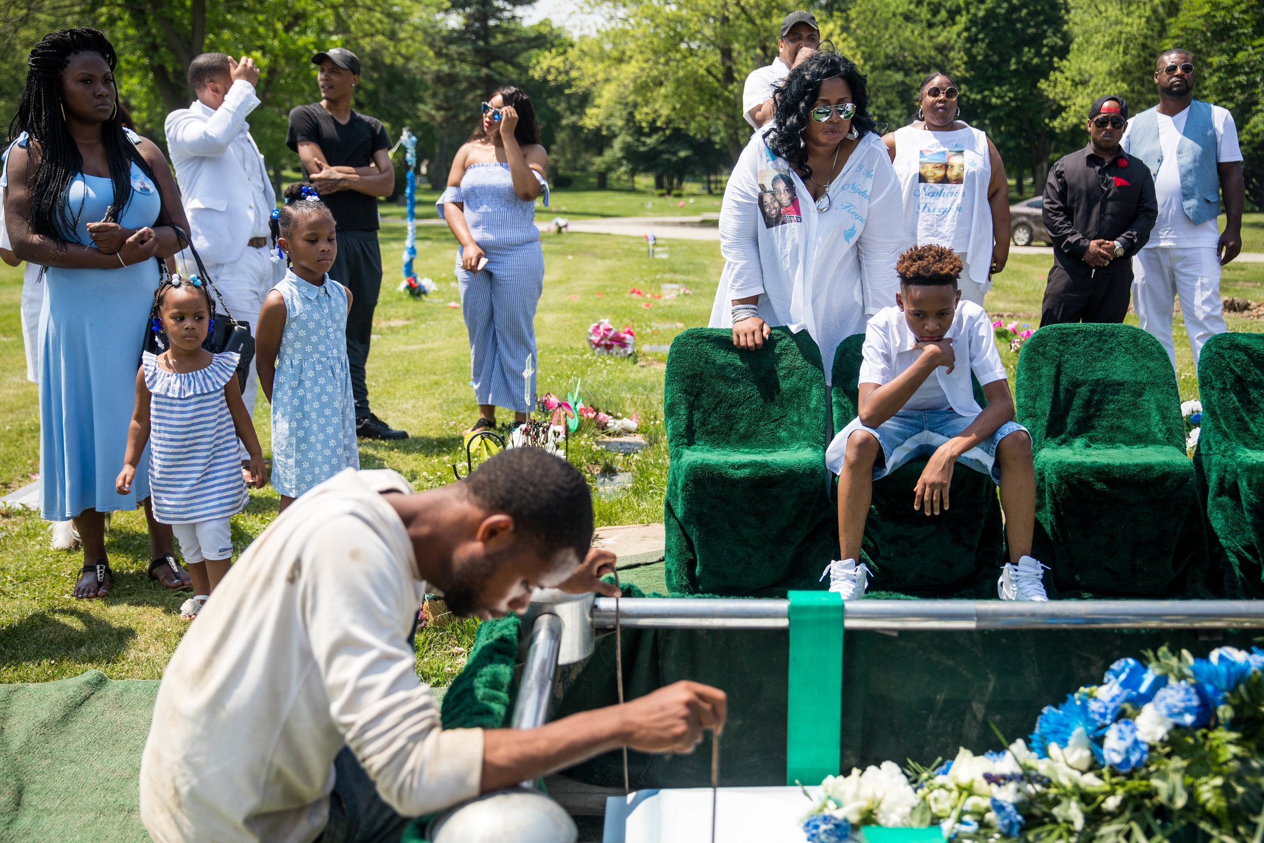  Family members watch as Jechon Anderson’s casket is lowered, during the funeral for the 11-year-old, at Mount Hope Cemetery, on Saturday, June 16, 2018, in the South Side of Chicago. He would rap about “putting guns down” with his stepfather before 