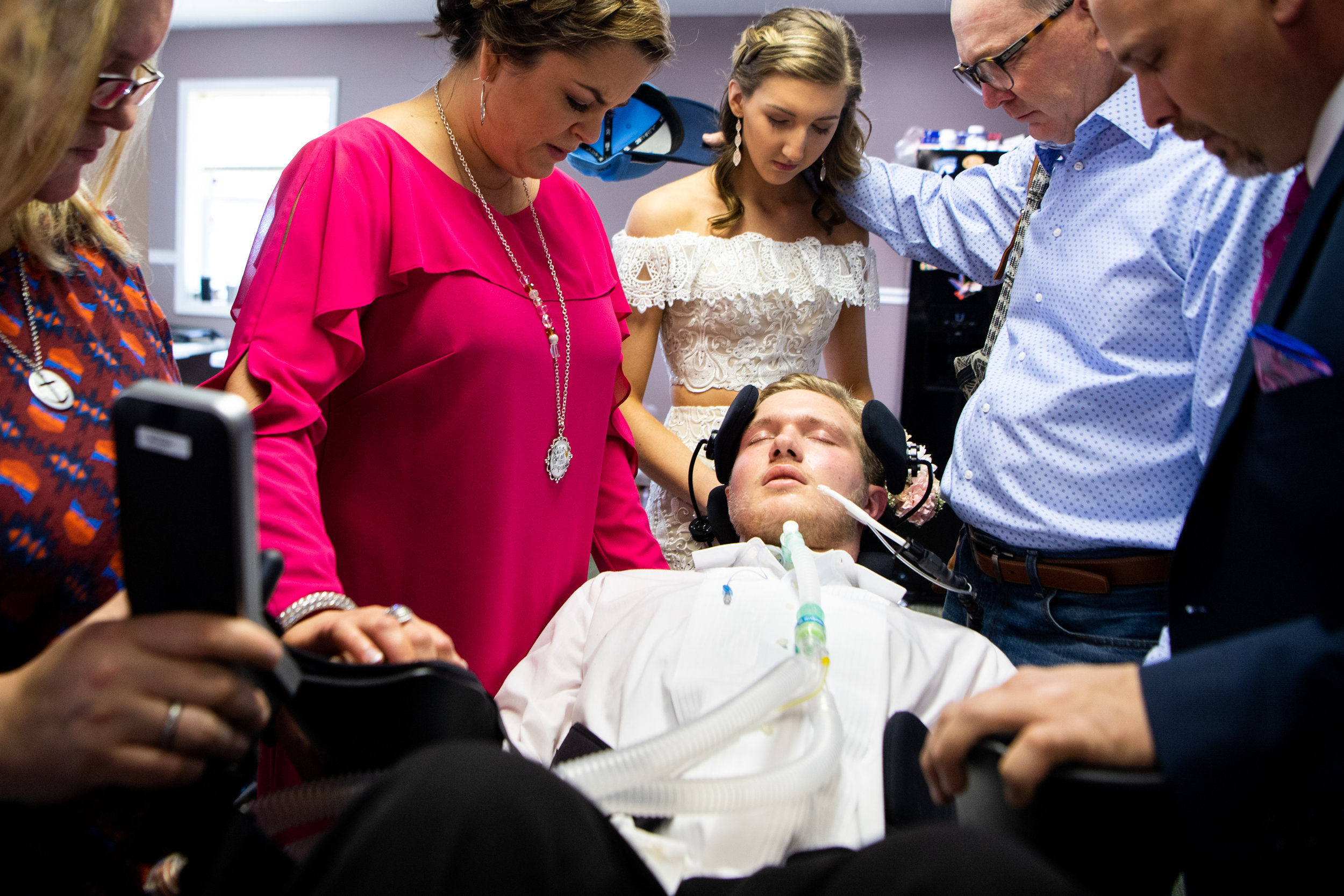  After a hard night and in pain, Jefferey Cox is prayed over by friends and family before going to prom with his girlfriend, Landry Clardy, at his home Saturday, April 20, 2019, in Erin, Tenn. Cox became paralyzed from the neck down during a preseaso