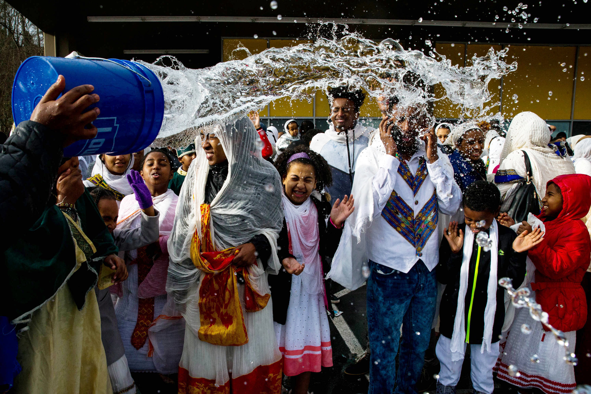  Congregants have holy water thrown on them during Timkat, the Ethiopian Orthodox Epiphany celebration, at Kings Hall in Seattle on Sunday, Jan. 21, 2018. The celebration started Saturday and continued overnight through Sunday afternoon. After the wa