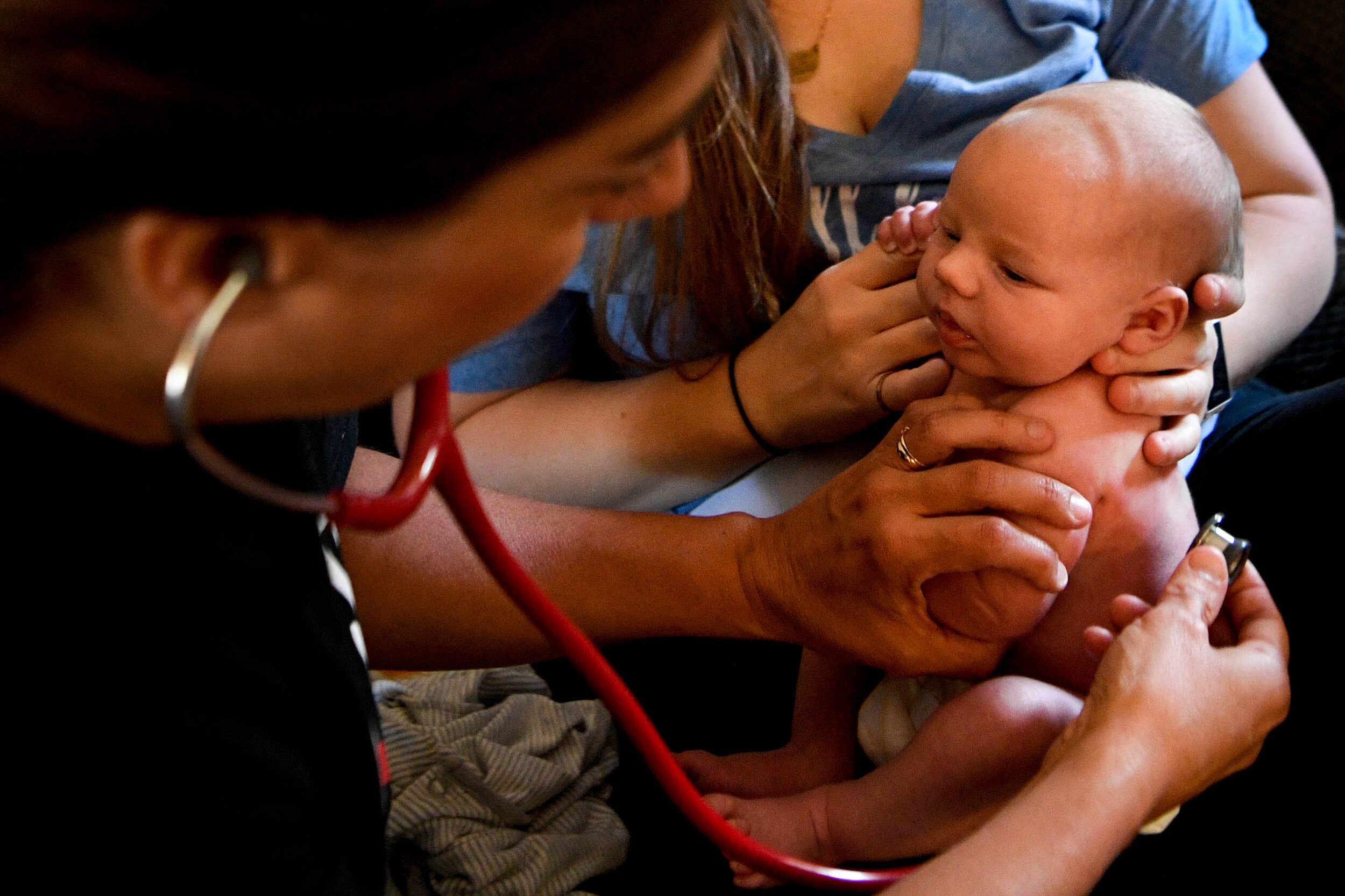  Midwife Gaylea McDougal checks over Henry Hudson during his 2-week checkup at his home outside Lebanon city limits.&nbsp; 