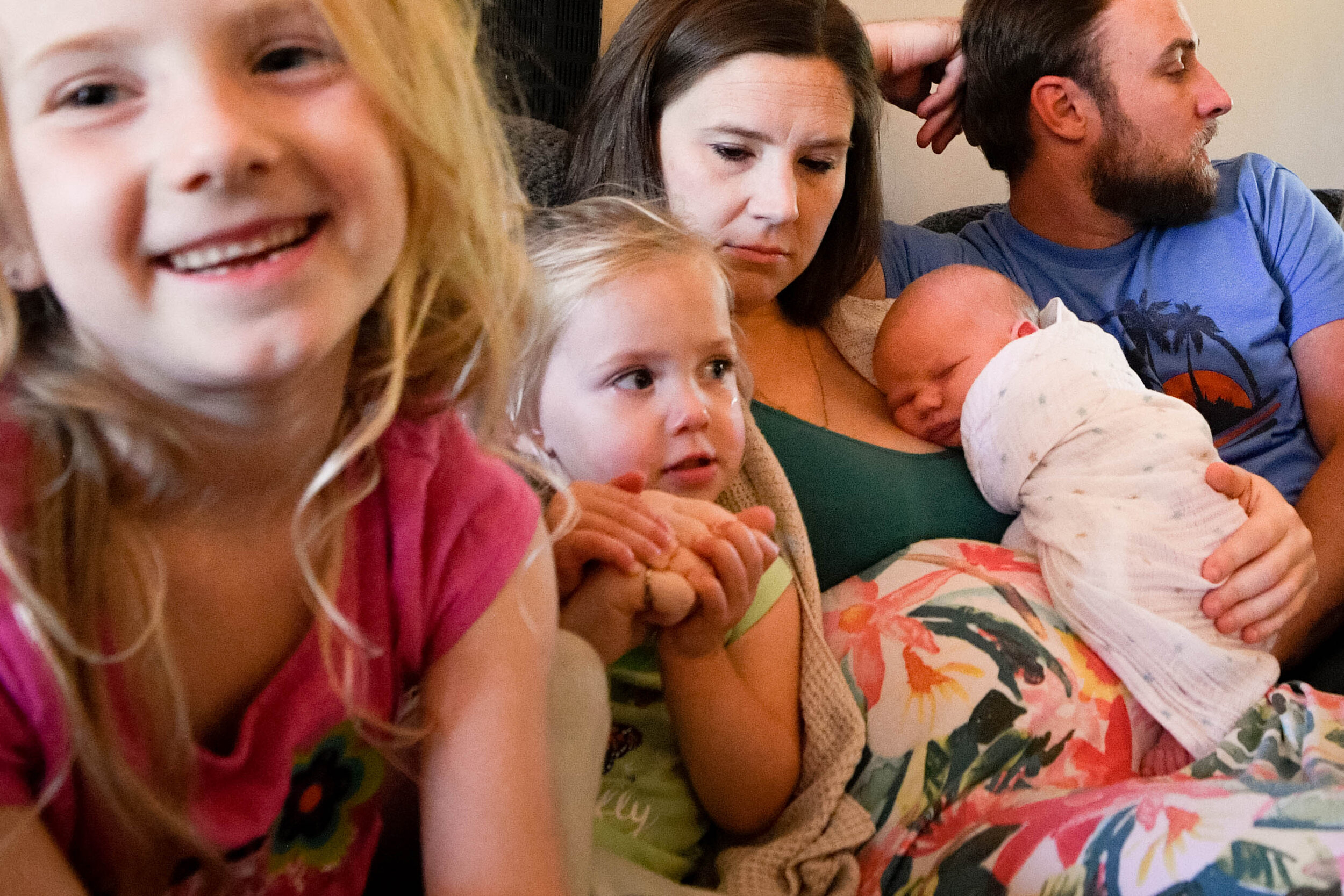  From left: Ruby, 7, Tessa, 2, mother Beth, Henry Hudson, 5 days, and father Eric Wehmeyer sit on the sofa together at their home outside Lebanon city limits.&nbsp; 