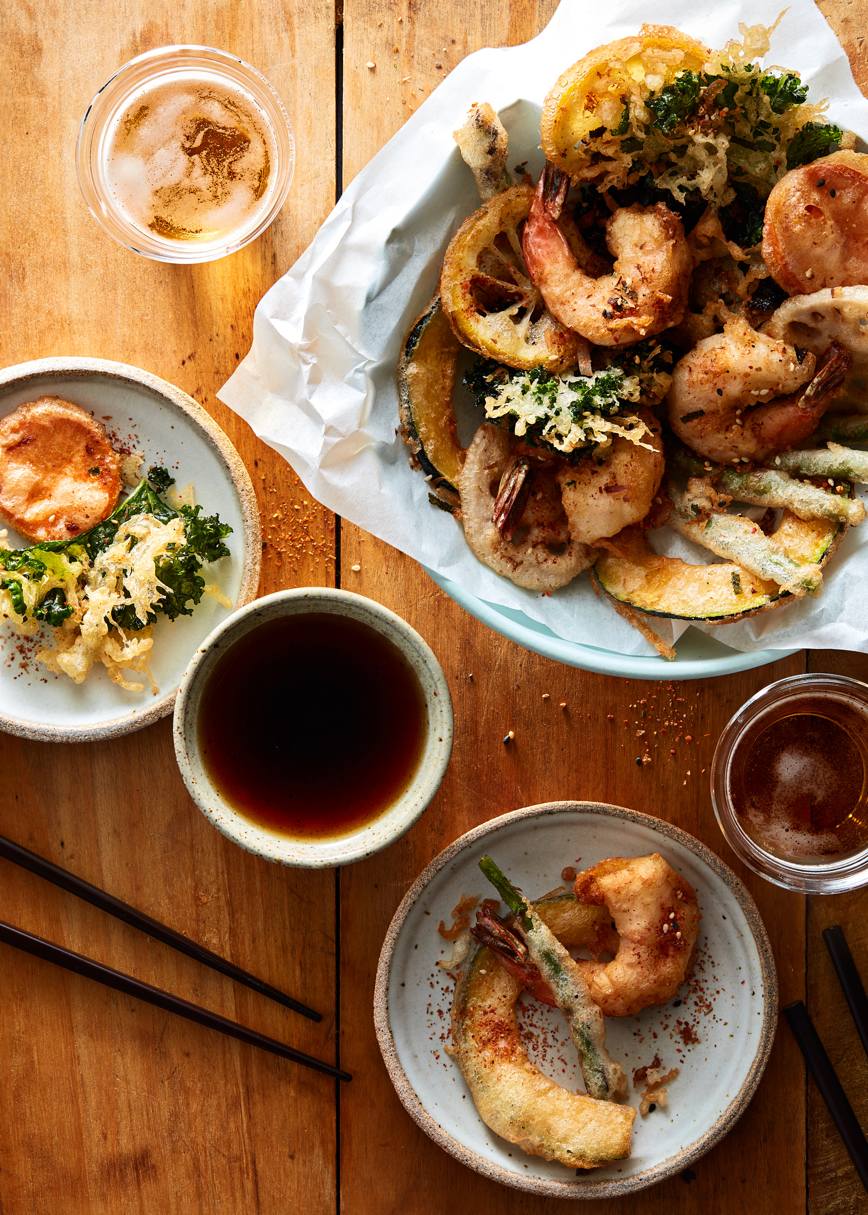 Shrimp and Vegetable Tempura with beer on a warm wooden surface.