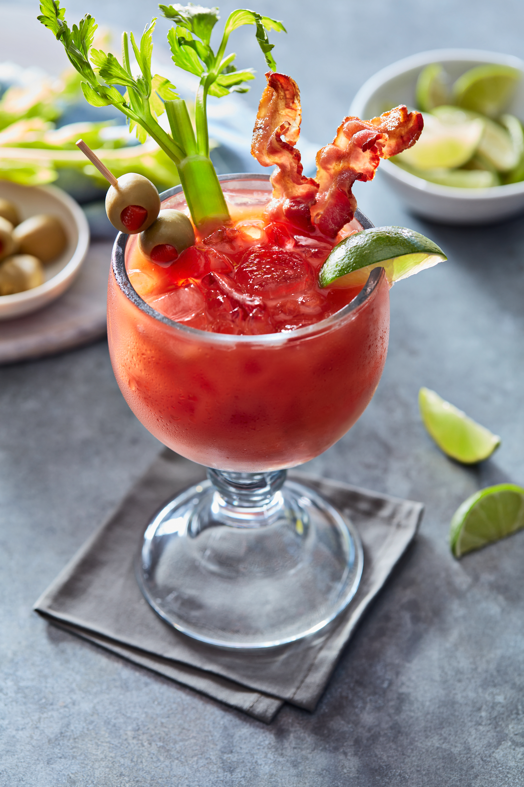 Bloody Mary cocktail with bacon, celery and pimiento stuffed olives. 