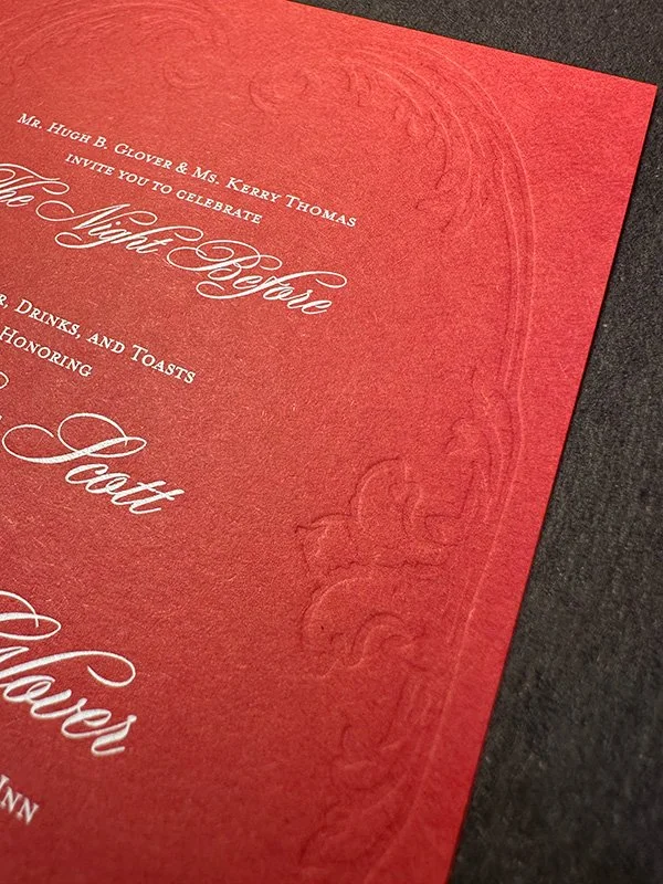 Digitally printed white type on scarlet paper with letterpress blind deboss