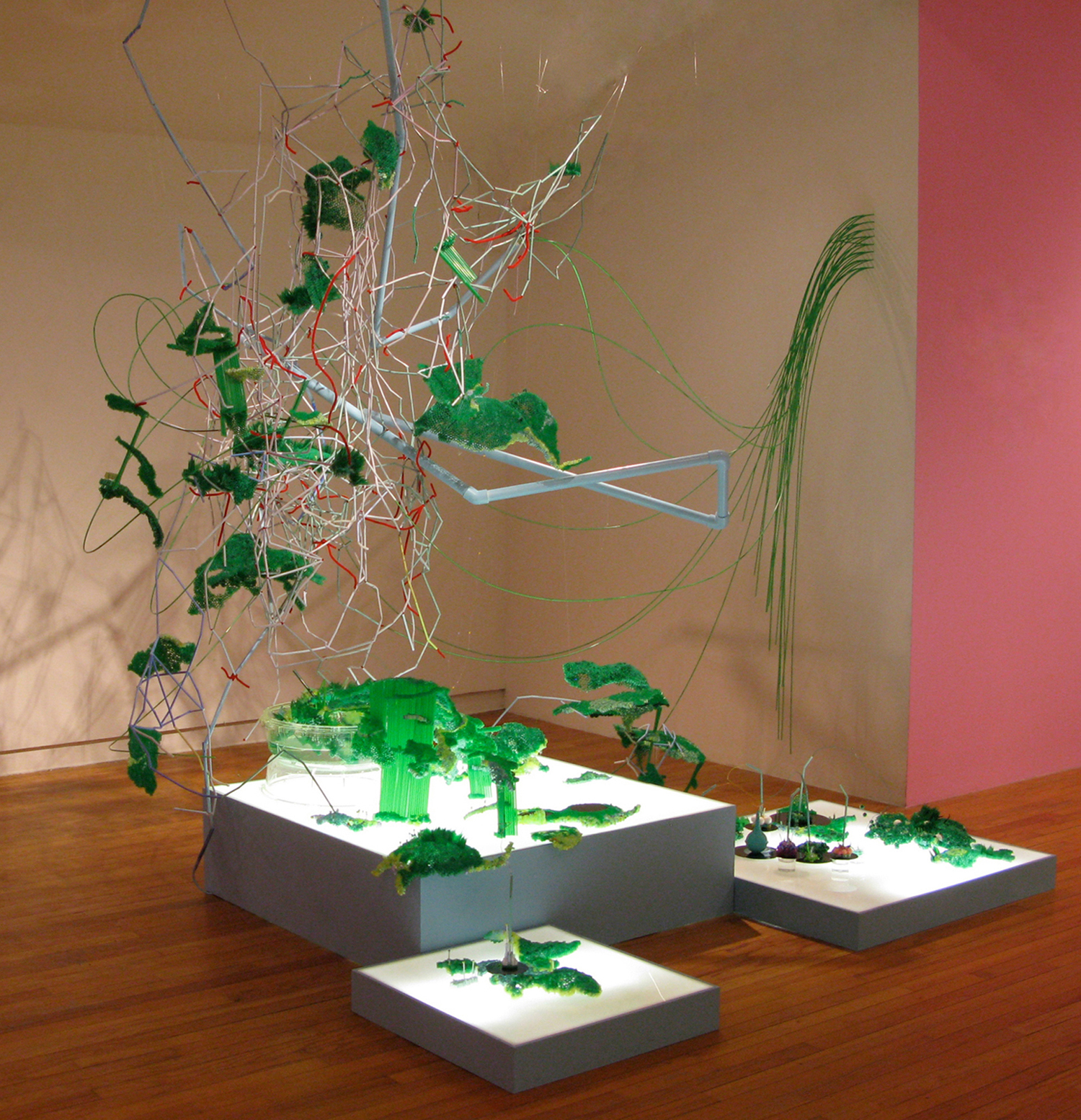 “Oh Varian Sea” The origin of “Oh Varian Sea” came from finding unusual used lab equipment in a chicken coop while I was on a residency in California. Mulling over the damaging effects of industrialization and consumer culture on the natural landscape, “Oh Varian Sea” is an imagined scientific landscape. In this piece, the mysterious lab sample explodes into a synthetic wonderland composed not only of the found scientific objects, but also miscellaneous debris, pvc pipes, multi-colored wires, and electric green drinking straws linked together, suggesting slime tubes. With references to nature and the blooming spring, this lab-scape, as the title suggests, is a play on production, reproduction, and the spirit of growth. Plastic drinking straws, mixed media 12’ x 9’ x 10’