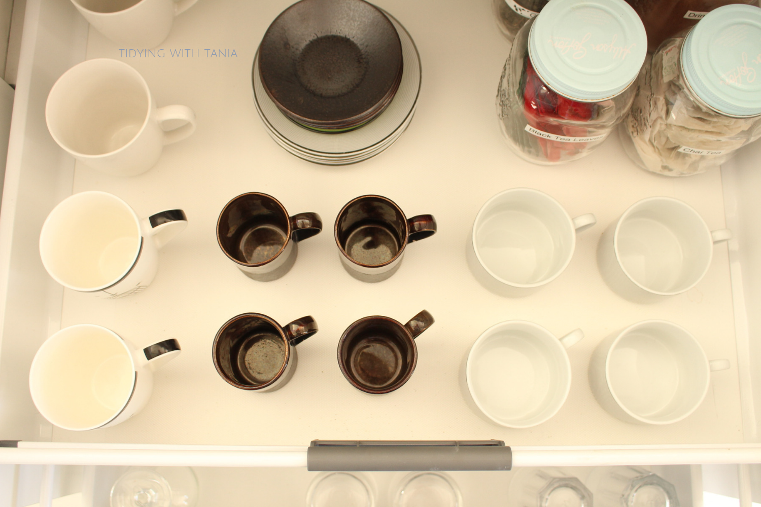 mugs and cups in drawer.png
