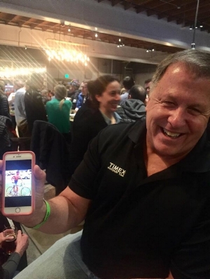 Dave holding a photo of his 1978 self competing in the first Ironman Triathlon
