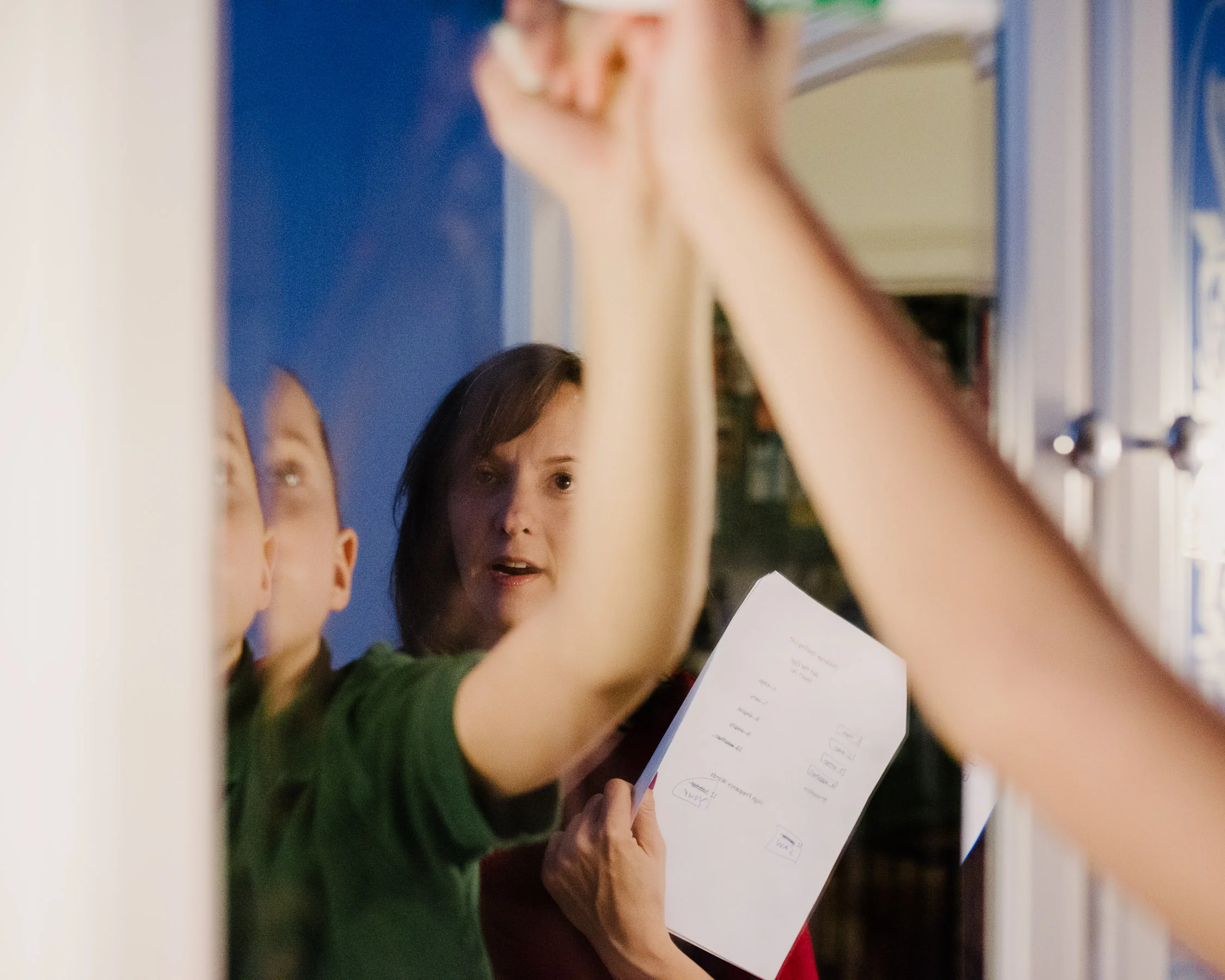 Deborah Gilboa helps her son Gavir with his spelling homework while her husband Noam prepares dinner.
