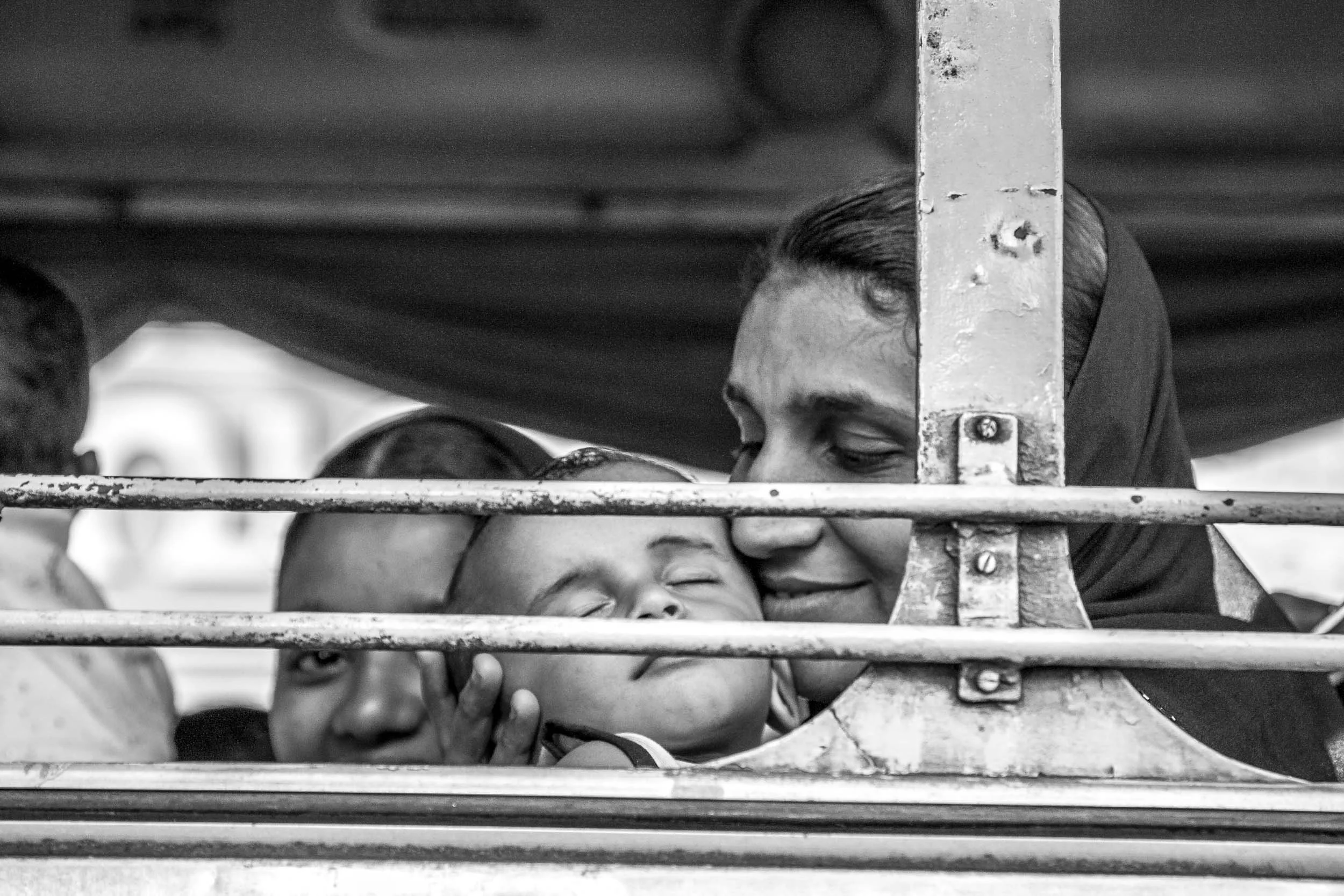 MOTHER AND CHILD IN BUS. OACHIRA, KERALA, SOUTH INDIA.