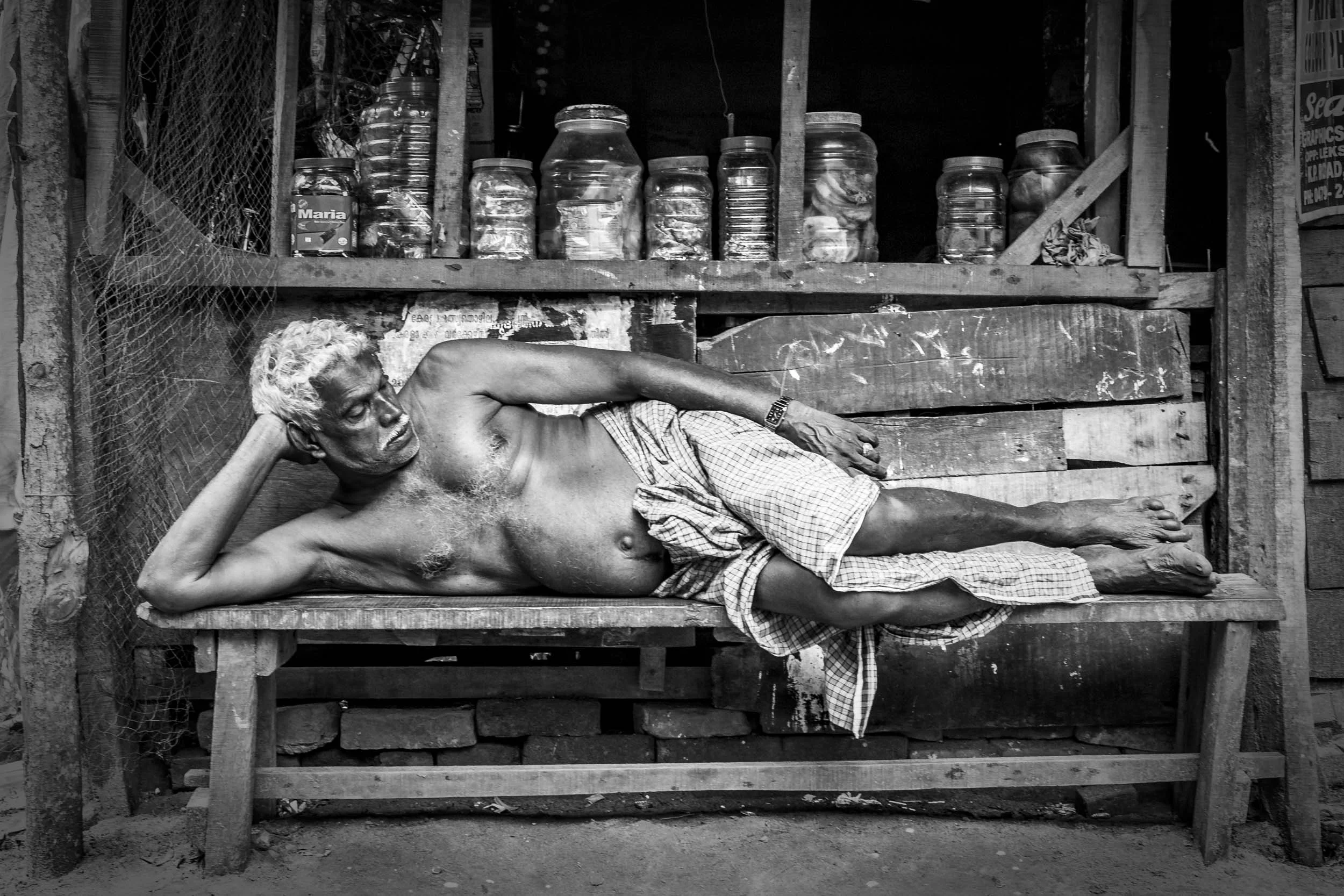 VENDOR NAPPING IN VALLICKAVU, KERALA, SOUTH INDIA.