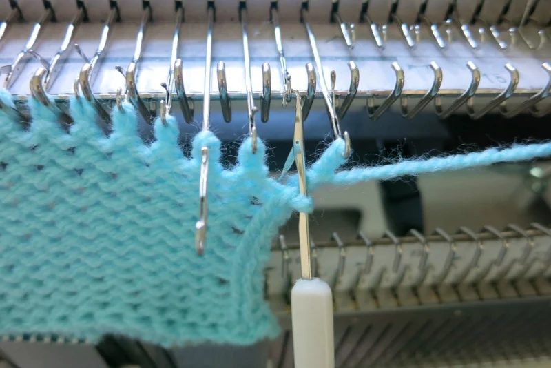 Hook the last stitch back to the needle.