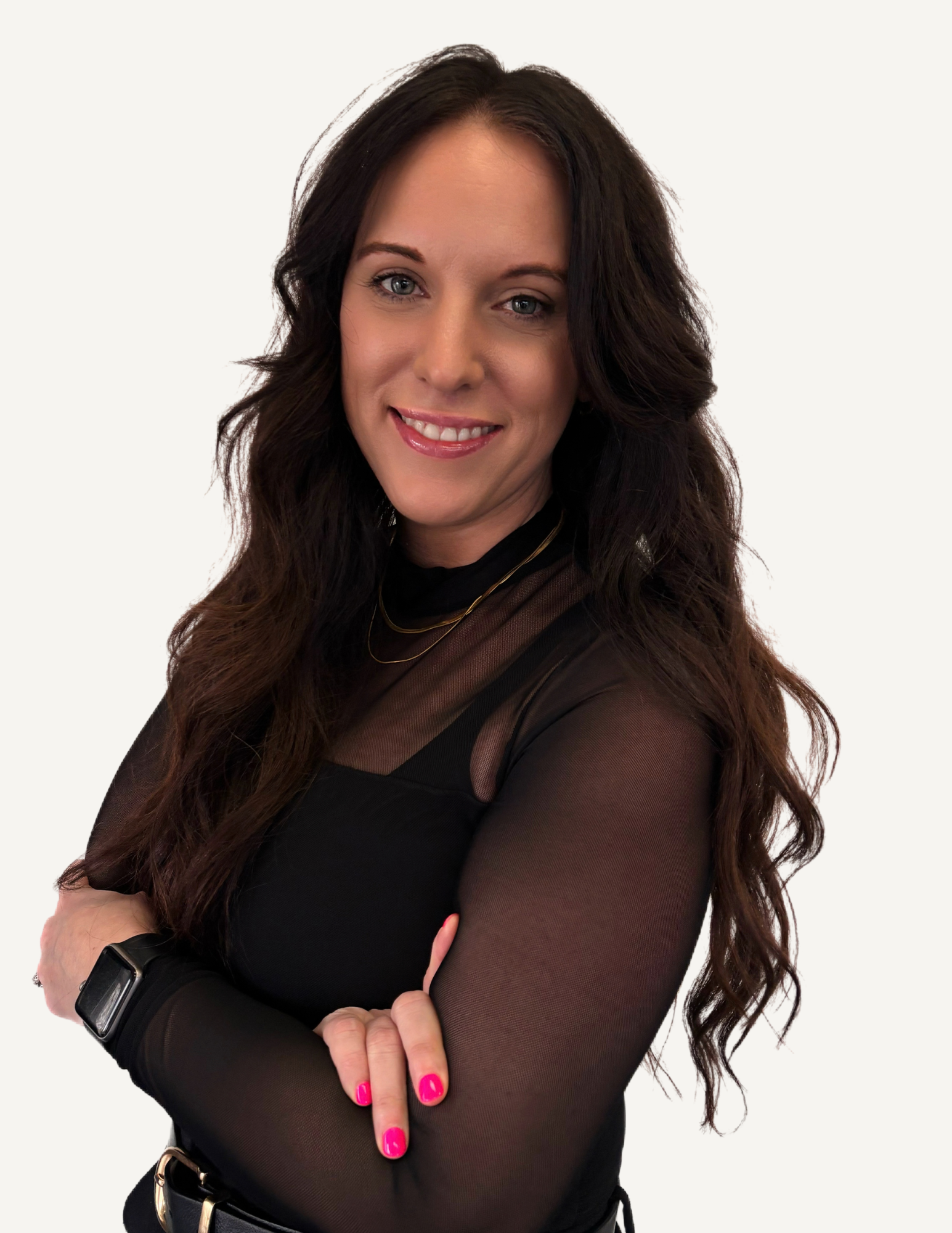 A woman with long dark hair and blue eyes smiling indoors.