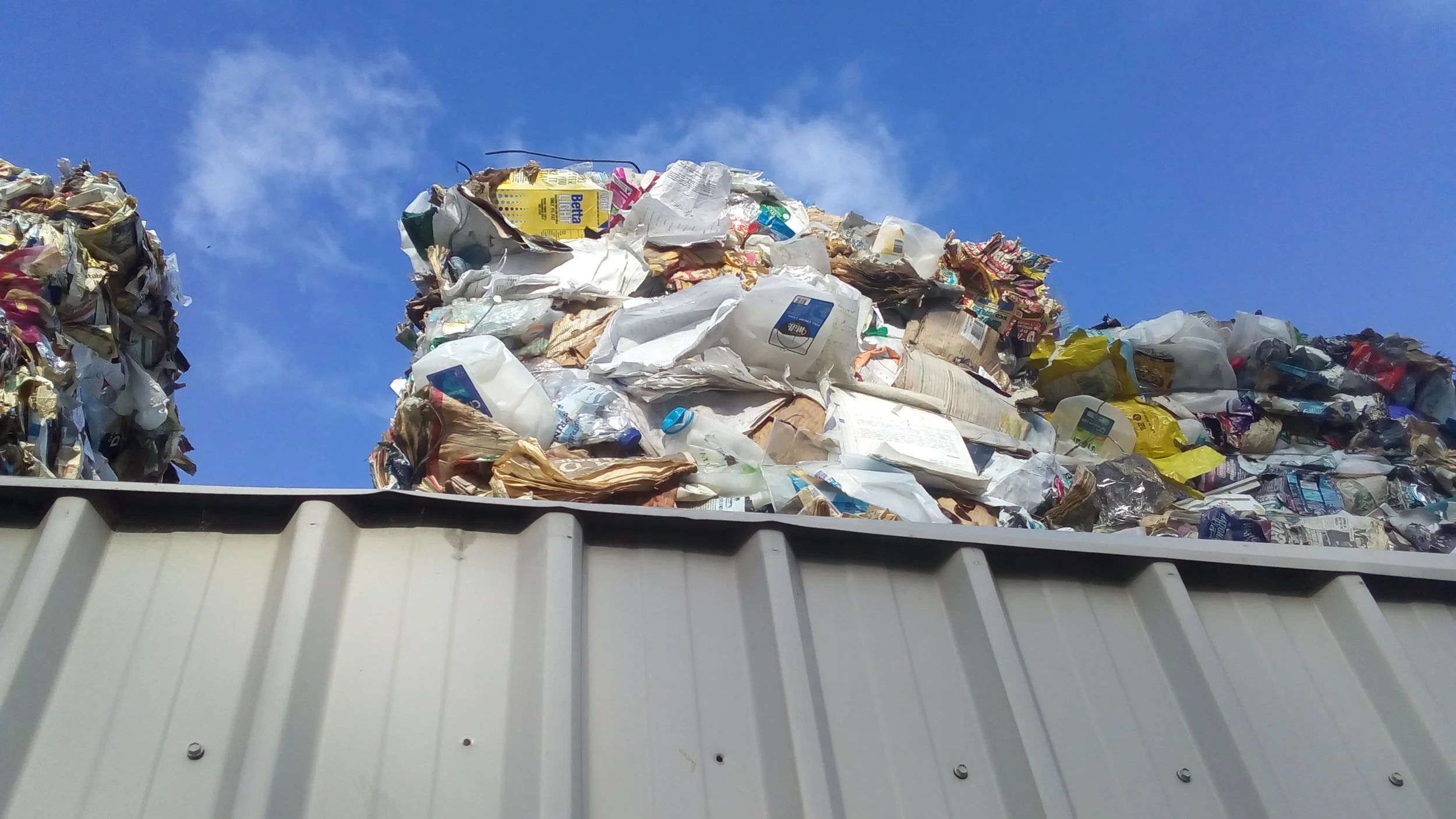 The Local Government Association refers to this stockpile as plastic containers - I can see lots of paper, card board, a milk carton and possibly soft plastics: none of it being recyled.