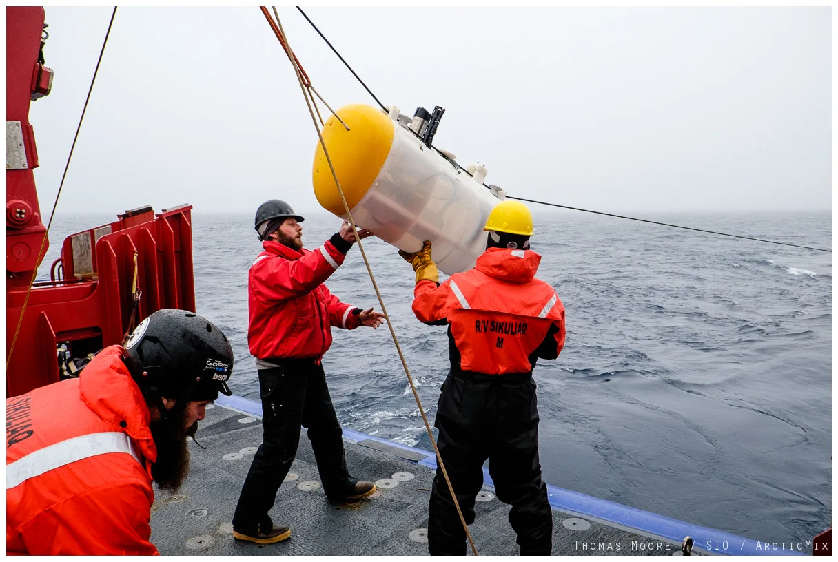Crew of the R/V Sikuliaq ease a MP robot over the side.