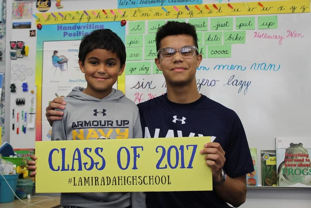 La Mirada High School senior graduate Ryan Rodriguez (right) talked about how he decided to attend the Naval Academy in his little brother’s (left) third-grade class as part of Norwalk-La Mirada Unified’s inaugural Kinder to College event. &nbsp;