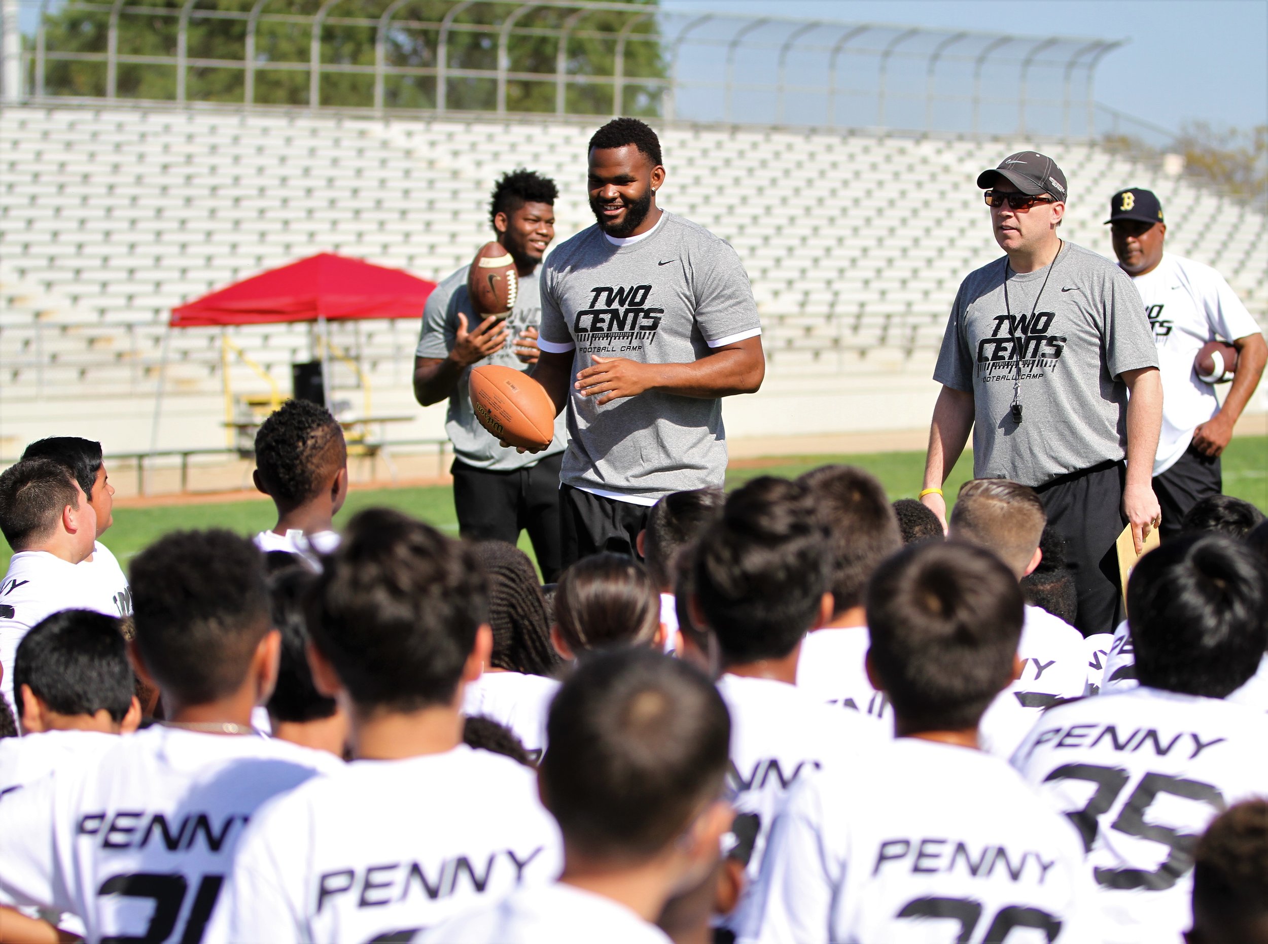 Penny brothers return to Norwalk for kids football clinic