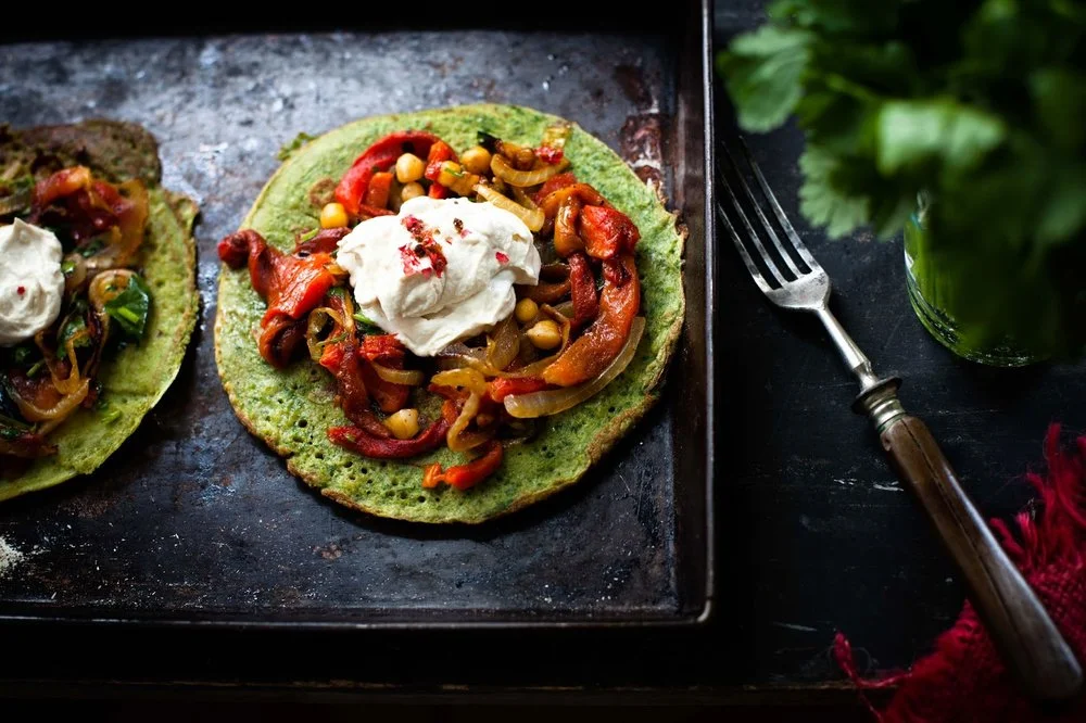 Buckwheat and spinach pancakes with roasted pepper, chickpea and tahini yogurt cream