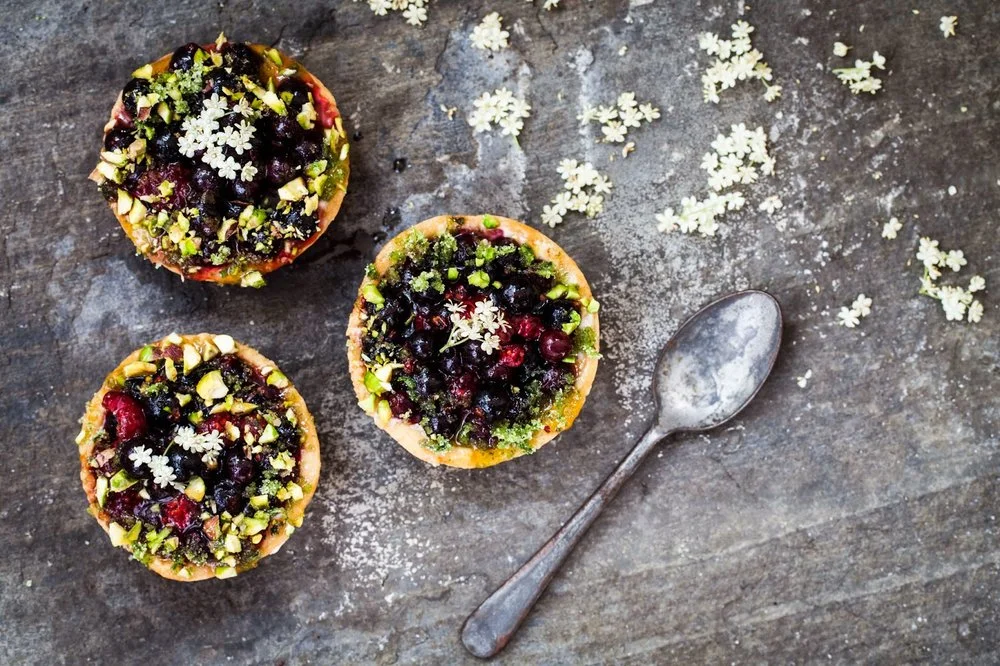 Blackcurrant and lemon verbena tartlets with elderflowers