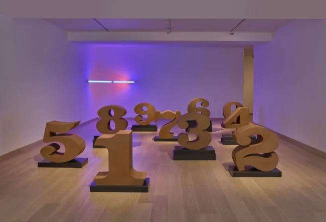 Installation view of Found in America with works by Robert Indiana, ‘ONE through ZERO’ (2003) and Dan Flavin, ‘Untitled’ (1969). Image courtesy of the Waddington Custot gallery