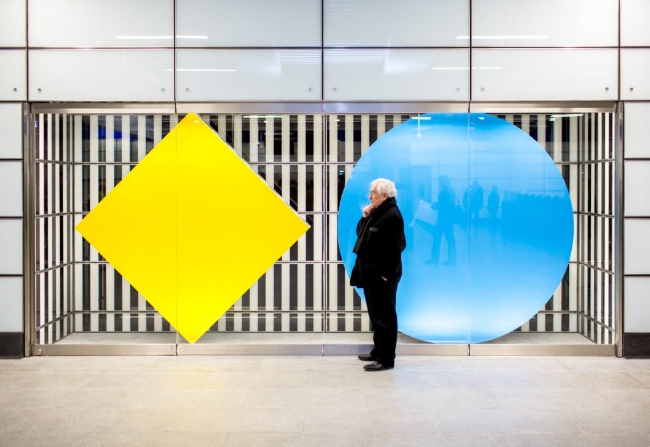 Daniel Buren with his installation at the Tottenham Court Road tube station. Photo by Benedict Johnson.
