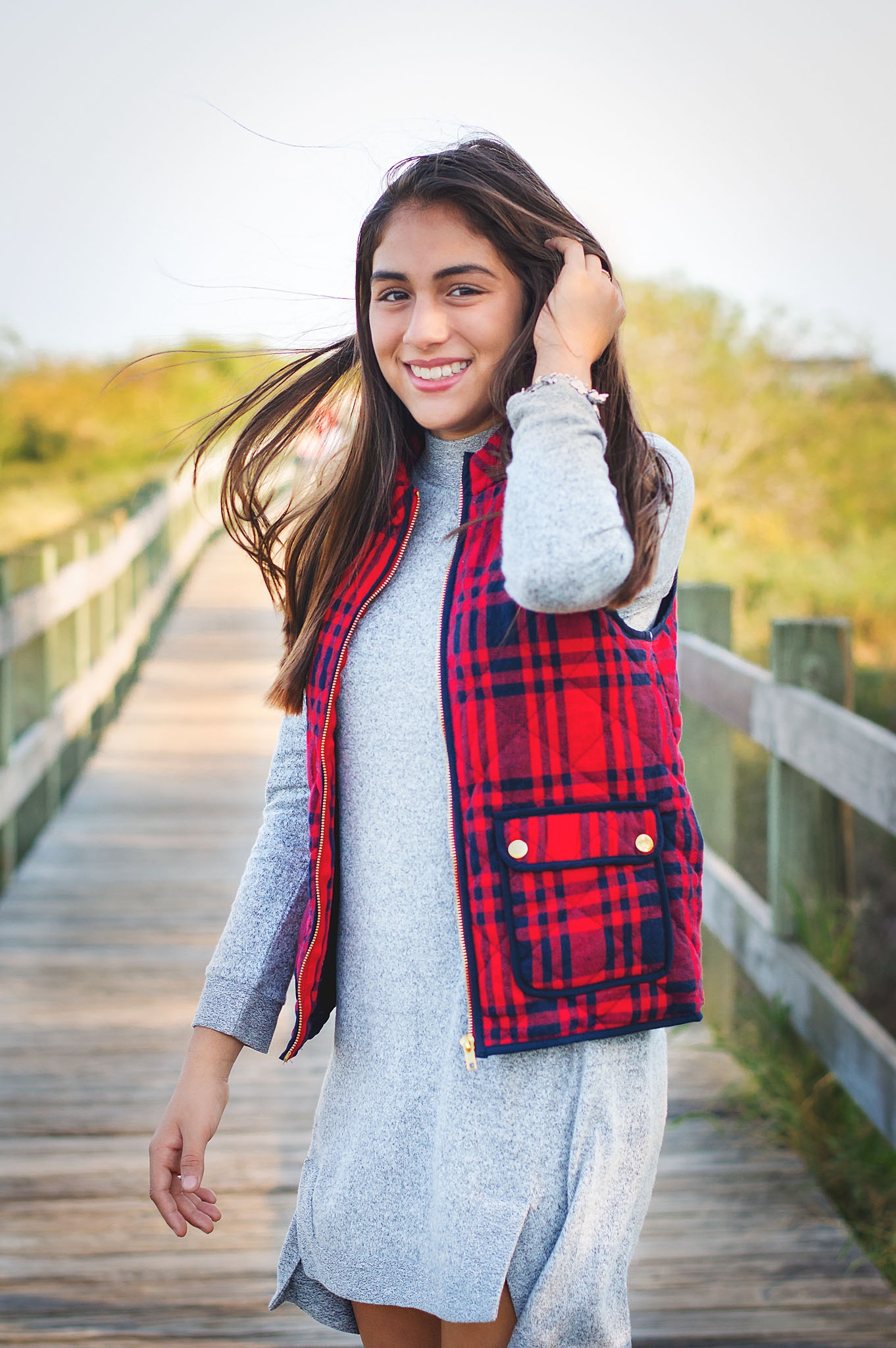 A simple solid dress is taken to a new level with the fun texture and bold color of the plaid vest.