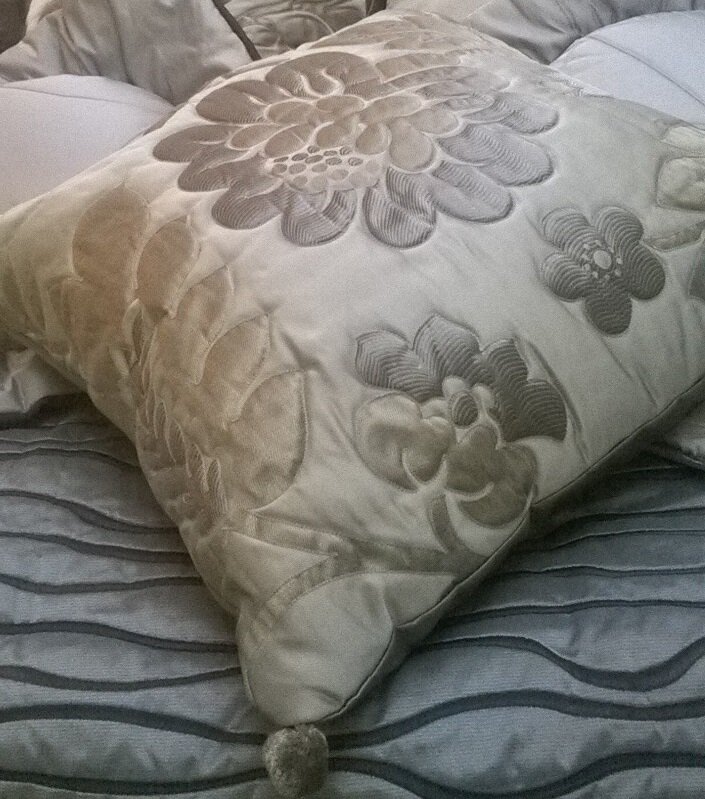 Showroom 11 quilted cushion with pompoms.jpg