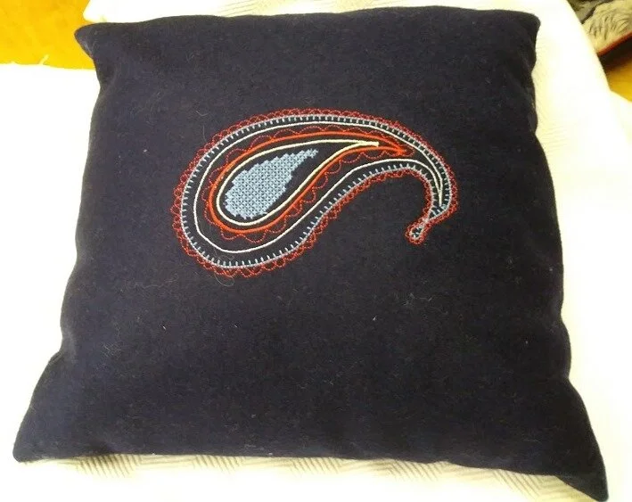 Paisley embroidered on to blue wood cushion.jpg