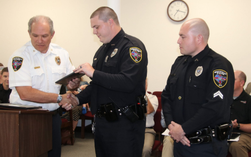 Police Chief Jeffrey Rozier, left, presented officers Mark Corder, center, and Jonathan Rawls with citations during Tuesday’s city council meeting for what he termed “professional and heroic” actions after an armed robbery in May.