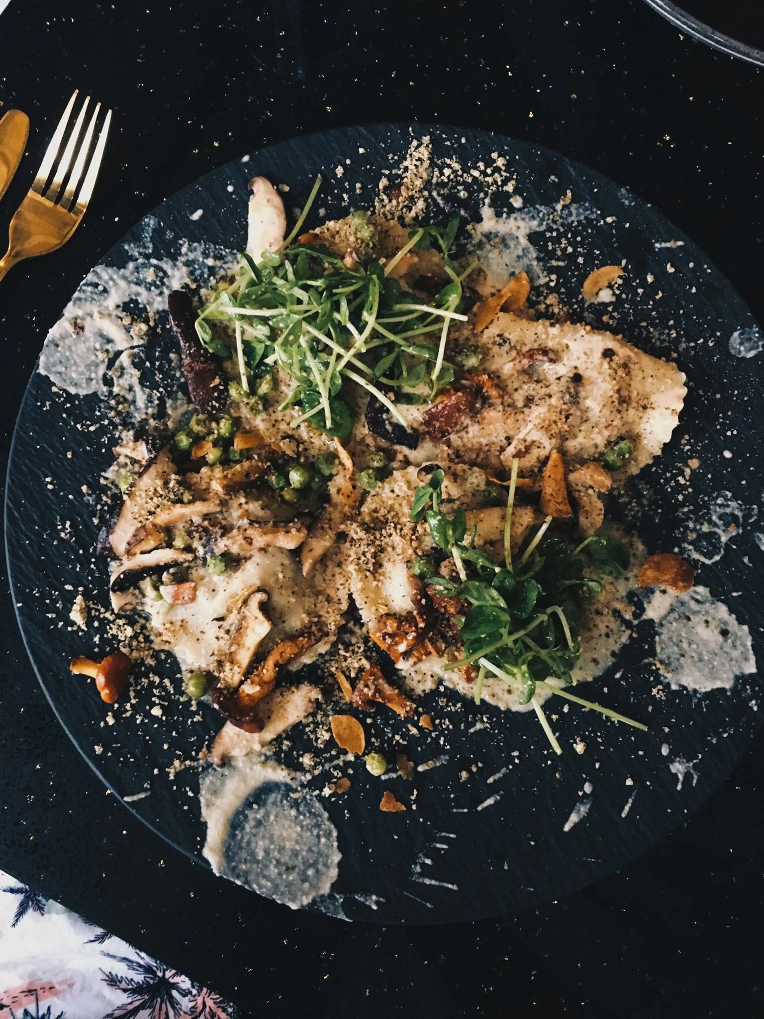 Mushroom Ravioli; Handmade Ravioli, Mushroom Duxelle, Porcini Cream Sauce, Wild Mushroom, Green Peas, Hazelnut Crumb, Baby Greens, Garlic Chips, Truffled Lemon Vinaigrette, Porcini Dust