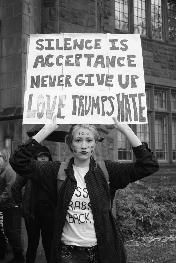 Photo by Leah Willingham '17 Cara Metivier ’19 holds up a sign in response to the election of Donald Trump as the president of the United States.