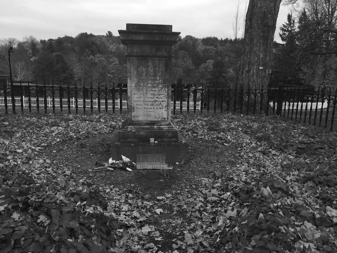 Photo by Hannah Roach '17 Founder Mary Lyon’s grave was adorned with flowers, candles and signs celebrating love and peace.