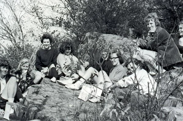 Photo courtesy of MHC Archives and Special Collections A group of Mount Holyoke students enjoy a picnic together, possibly at the top of Skinner Mountain on Mountain Day in fall semester 1965.
