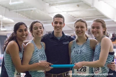 Photo by J. Cronin Outrageous Photography From left to right: Simone Jacob ’21, Emsie Cronin ’19, Head Coach Christopher Kibler, Corrin Moss ’19 and Sydney Nash ’22 celebrate after the Div-III New England Championships at Bowdoin College.