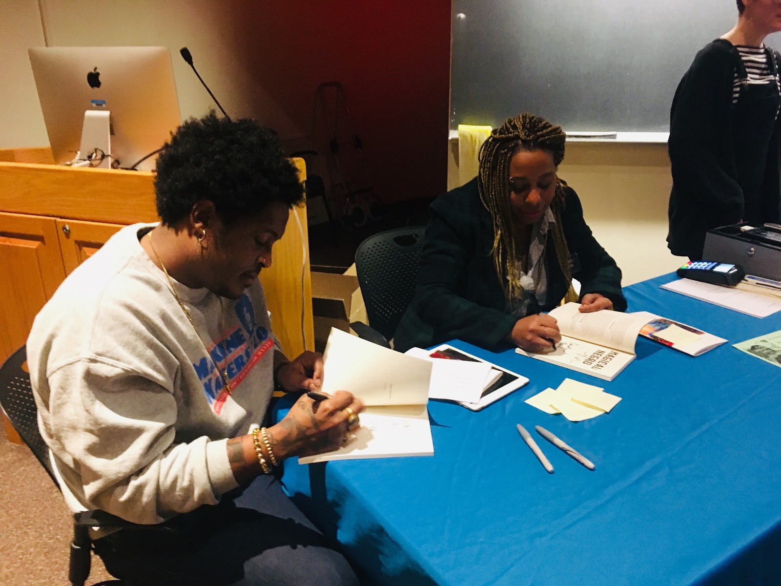 Photo by Caroline Mao ’22 Danez Smith (left) and Morgan Parker (right) sign their books after their talk.