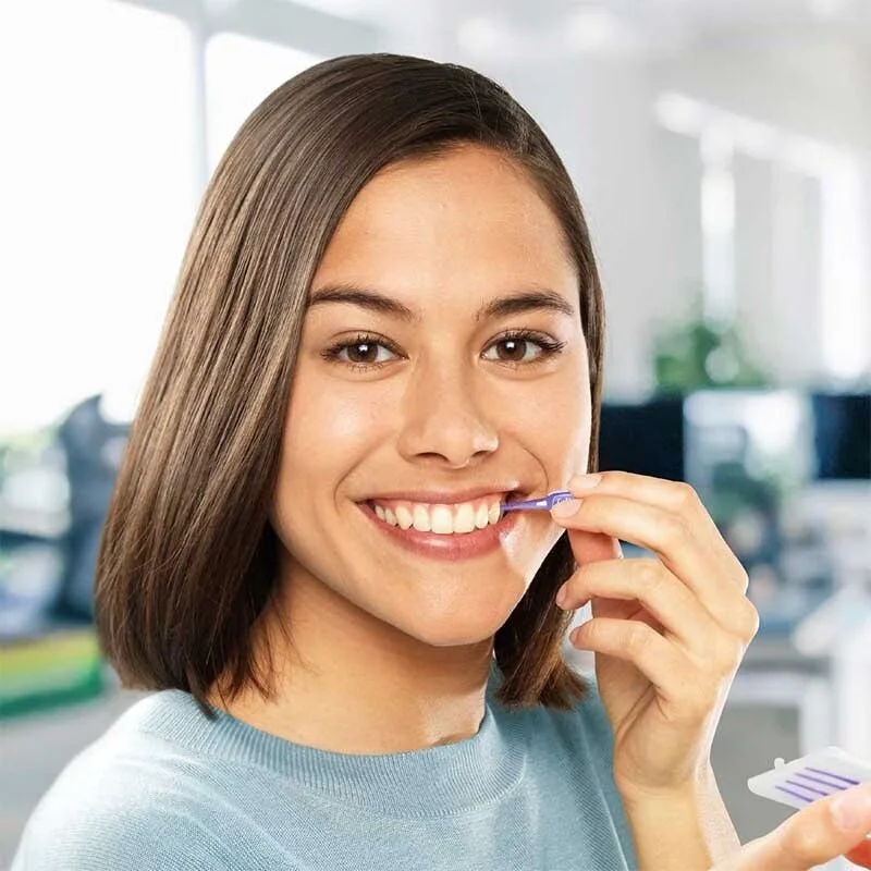 Woman smiling in office Using a TePe EasyPick