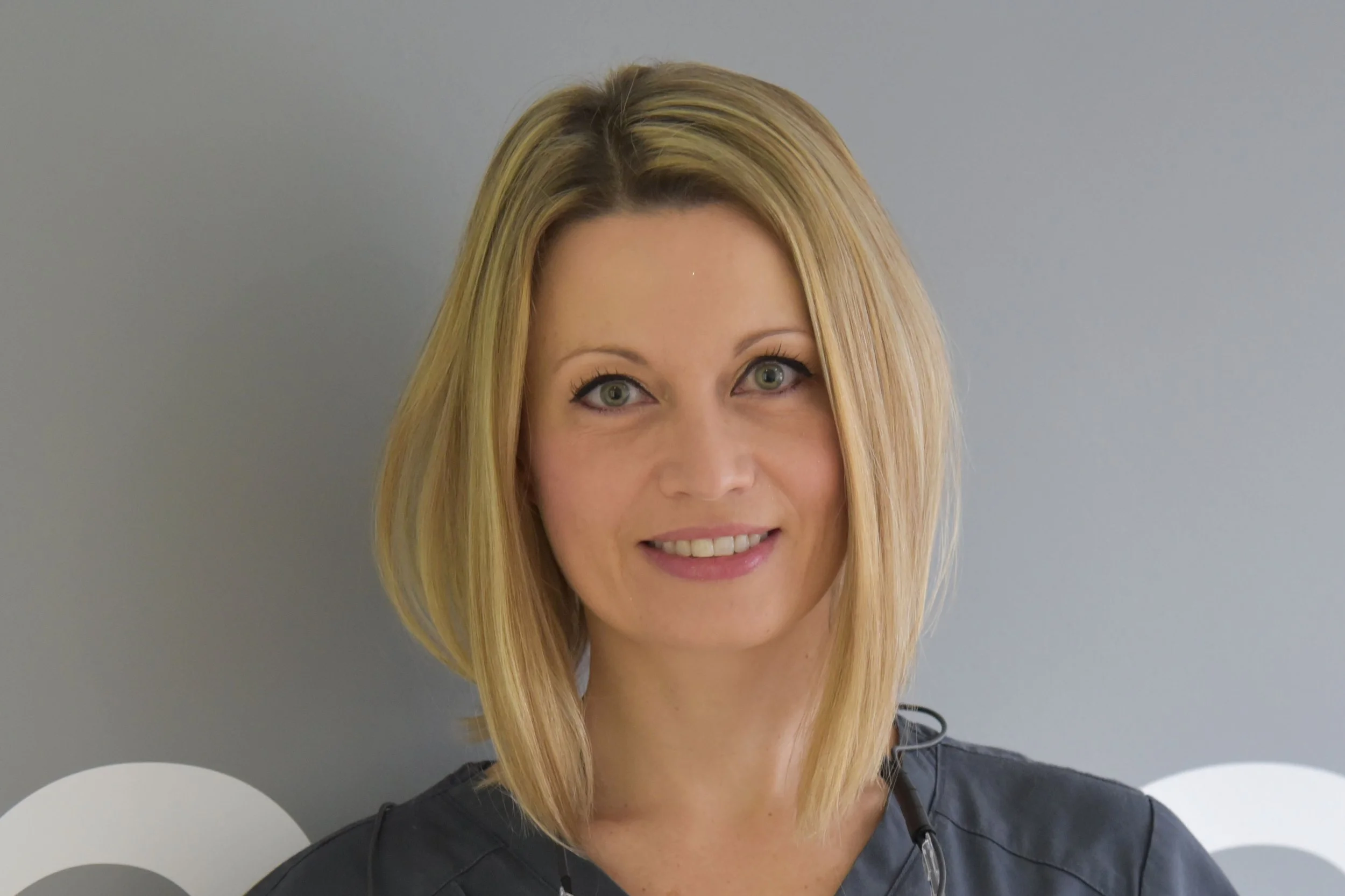 Image of an oral surgeon (dentist) smiling to camera
