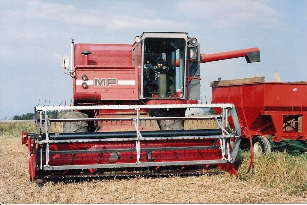 I'm possibly about 6 years old, on the farm of a family friend on PEI. Combines leave a lasting impression. Photo credit to Heather Tweedy.