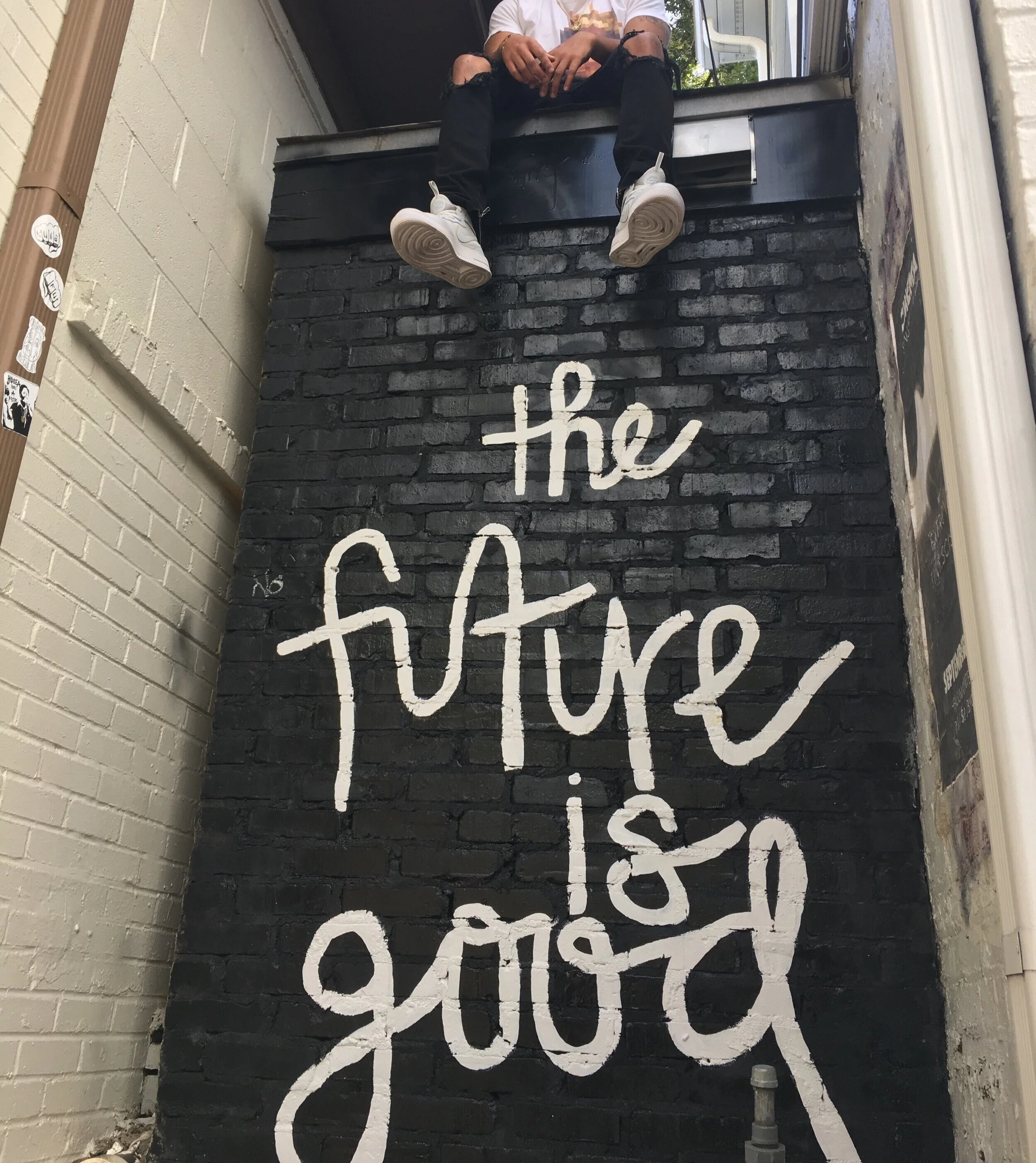 man-sitting-on-top-of-wall-with-the-future-is-good-print-2364475.jpg