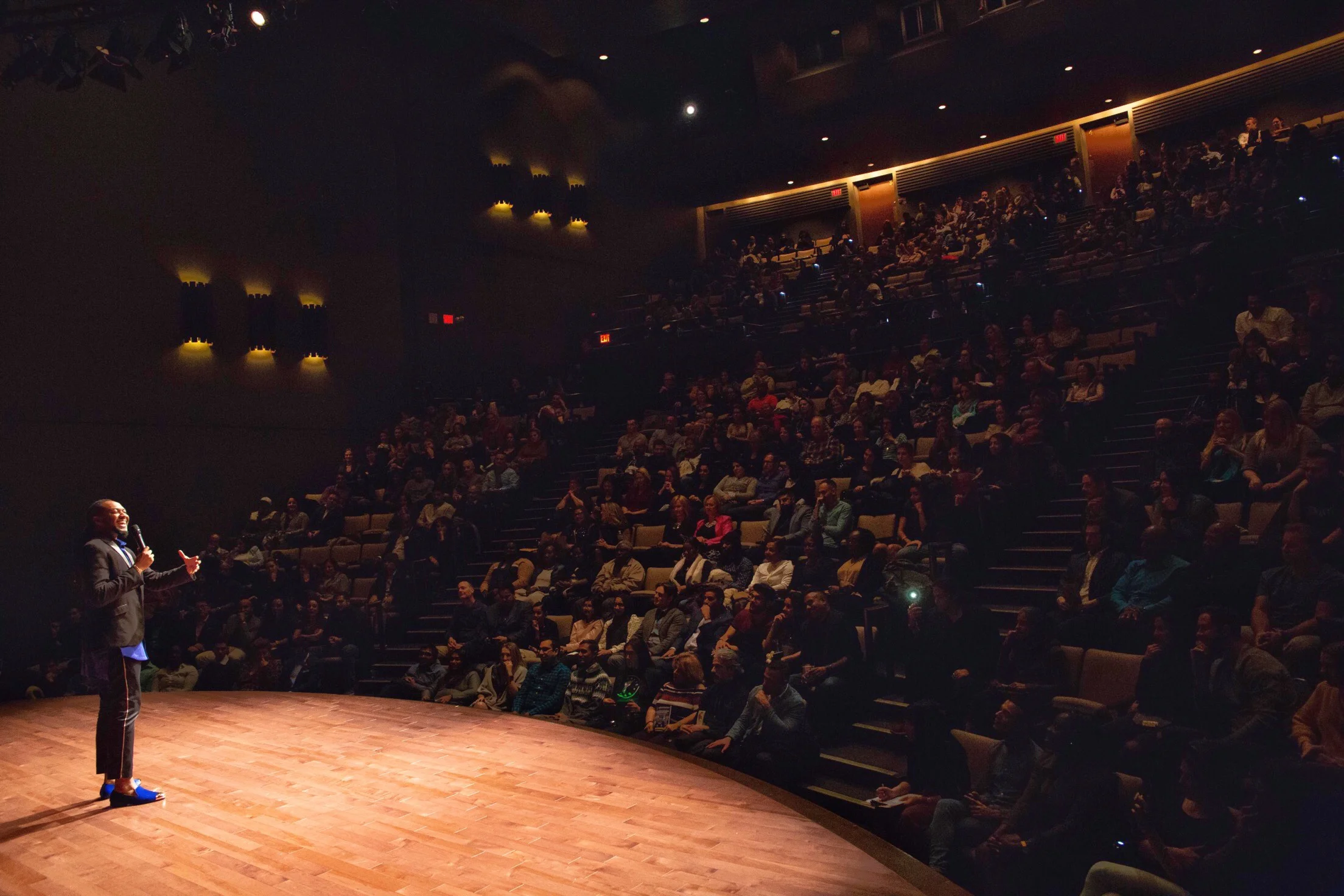 Dejehan Hamilton speaking to a full theatre audience