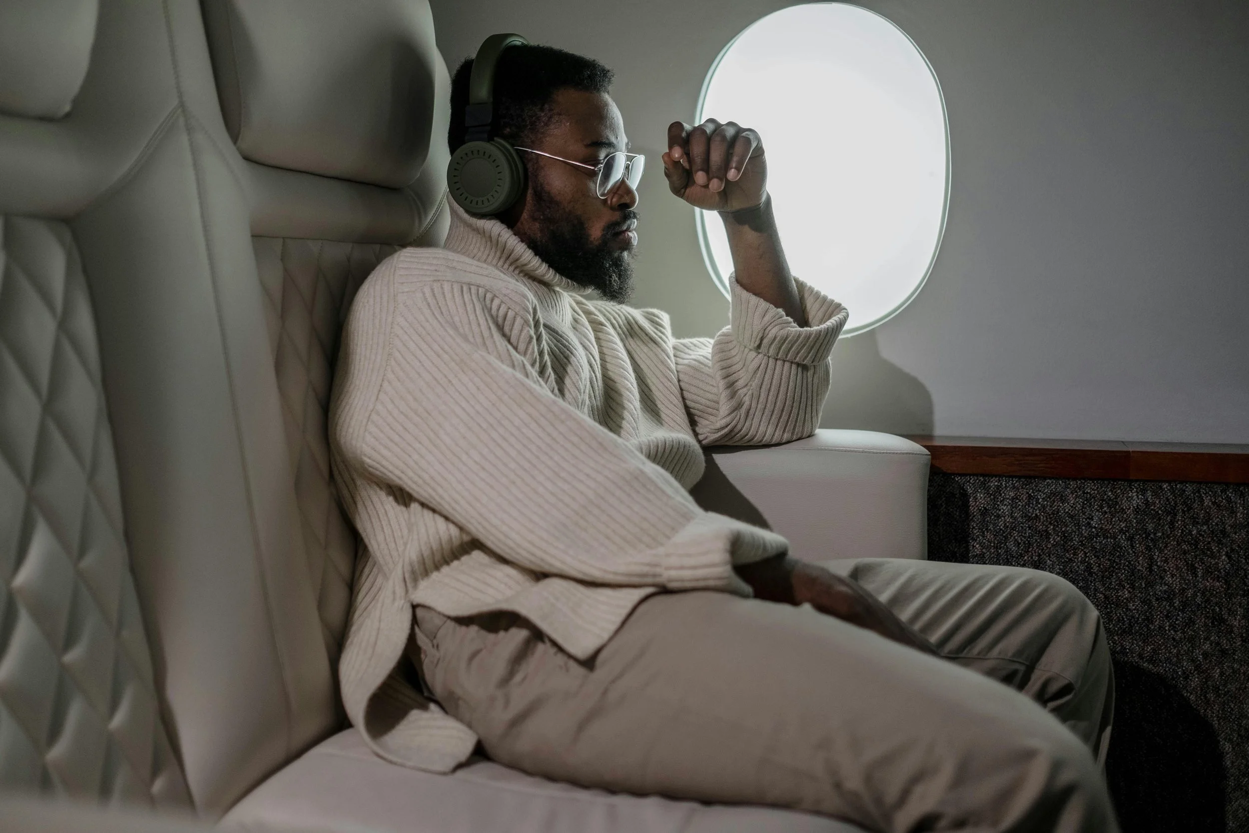 Talent agent in call with entertainment lawyer in private jet, discussing contracts, intellectual property protection, disputes and commercial transactions.