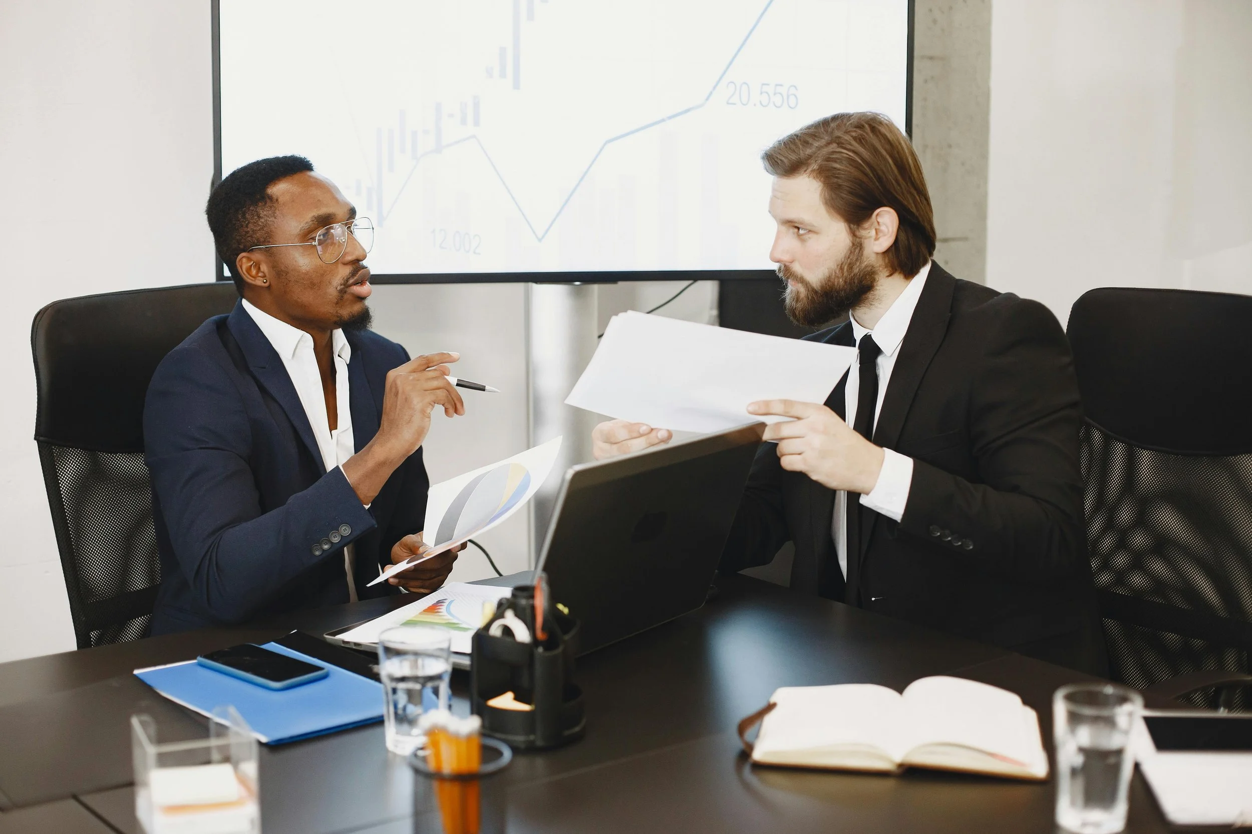 Business professionals reviewing employment agreement related to Florida non-compete litigation and prior breach defense