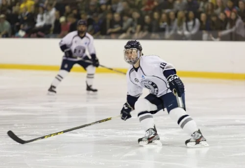 Senior forward Stephen Collins looks for a pass during the Ice Knights game against the Morrisville Mustangs on Saturday Jan. 28. The Knights snatched an 8-1 victory on Saturday after falling to the Mustangs the night before with a score of 5-2. (Annalee Bainnson/Assoc. Photo Editor)