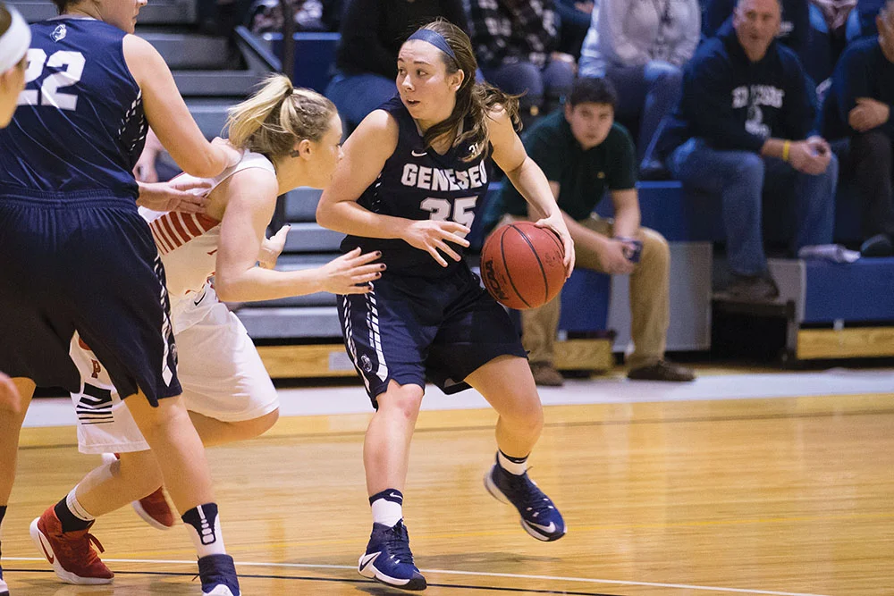 Sophomore guard Kelsey Poplawski looks for an open teammate to pass to during a game against SUNY Plattsburgh. The Knights remain undefeated and hope to maintain this victory streak. (Keith Walters/Campus Photographer)